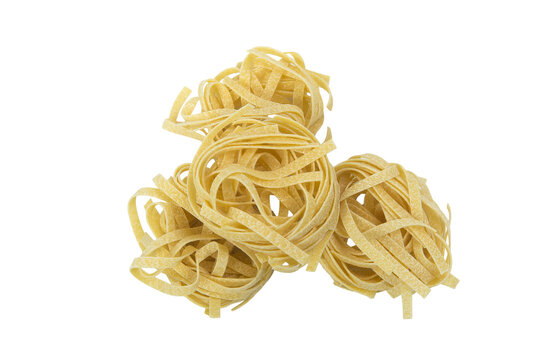 A pile of four nests of dry fettuccine pasta