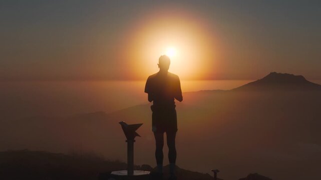 Man hiking and running on the top of the mountains at sunset time, at the Basque Country.