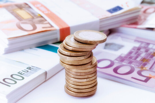 Stack of euro coins and banknotes, close-up