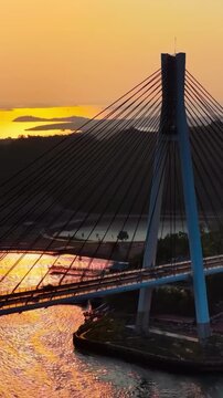 Aerial Sunset View of Cable Stayed Barelang Bridge Pylon Tower and Suspension Cables with Traffic Over Water