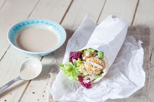 Homemade falafel with lettuce, tahini sauce in flat bread, Dueruem