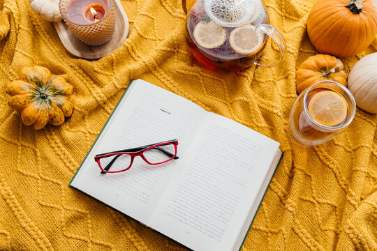 Autumn cozy moment reading book with hot tea