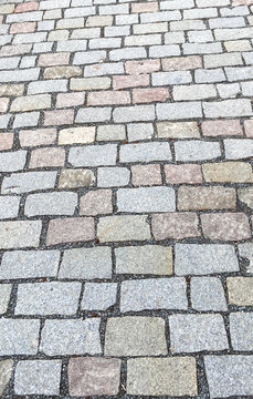 Top view texture pattern of old grey cobblestone pavement background on a European street
