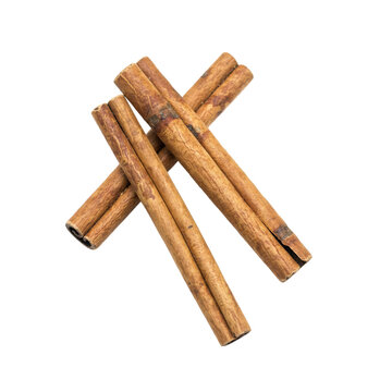 Three dried brown cinnamon sticks arranged in a crisscross pattern on a white surface isolated on a transparent background