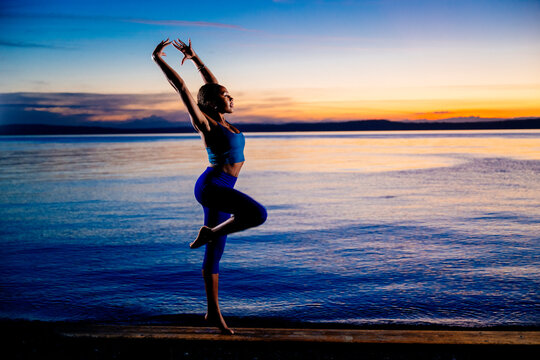 Hispanic woman practicing a yoga balancing pose