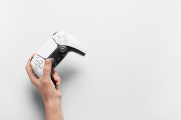 Gaming and entertainment industry, person holding a modern wireless video game controller for interactive digital leisure and home console play © Pixel-Shot