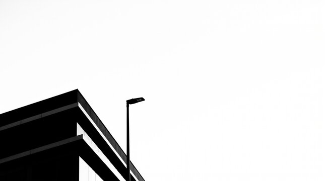 Geometric black silhouette of a modern building corner and street lamp on pure white background