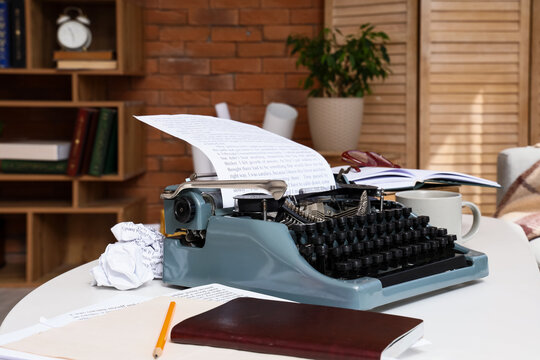 Creative writing and writer block concept, vintage typewriter with crumpled paper and manuscript on desk in home office for storytelling and literature