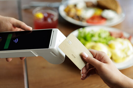 NFC payment with contactless card at restaurant point of sale