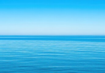 Fototapeta premium The vast blue ocean flows calmly towards a sharp horizon line under a cloudless sky, offering a tranquil and meditative natural scenery view, outdoors, simplicity, bright