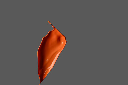 Splash of orange paint on dark background