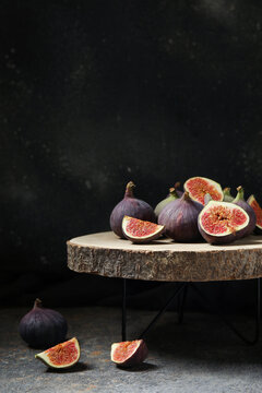 Wooden stand with fresh ripe figs on grunge table