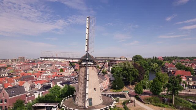 Molen van Piet in Dutch cheese market city Alkmaar, The Netherlands, seen from above on a sunny blue sky day with cityscape old town in the background