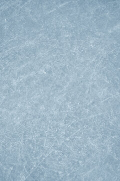 An ice surface as an ice rink with ice skates tracks. Winter sports texture. Poster with copy space.