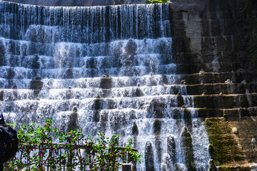 Cascading Waterfall Over Terraced Rock Formations © DinhThi