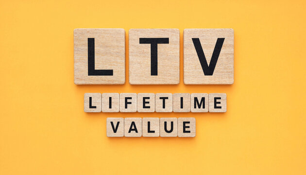LTV lifetime value concept spelled with wooden letter tiles on yellow background for business strategy and customer retention