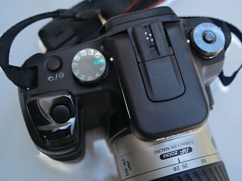 Digital SLR camera with zoom lens on white surface