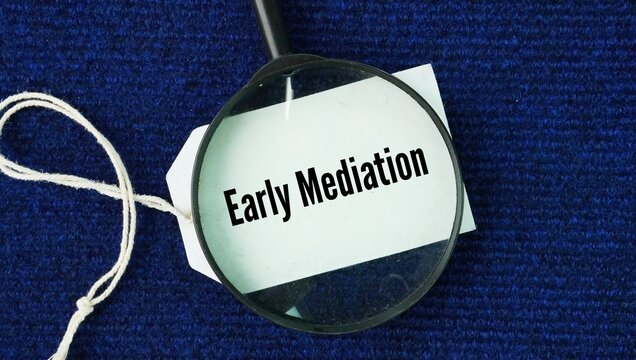 Magnifying glass and paper tag with the words Early Mediation. a voluntary or court-ordered process in which disputing parties meet with a neutral third-party mediator to resolve a conflict before inv