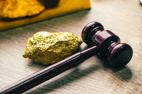 pure gold bullion bar 99.9 next to natural gold nuggets on a silver ore stone plate as a conceptual backdrop for global finance gold investment wealth safety haven banking economy and asset management