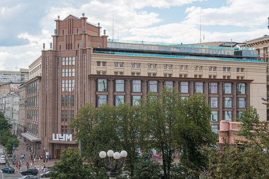 Urban landscape in Kyiv, Ukraine, on a cloudy day Main structure is a multi-storied building with classical architecture columns, ornate detailing, brown and whit - Kyiv, Ukraine 07-13-2025
