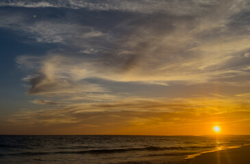 Fototapeta premium beautiful scenery at the beach with sunset and clouds