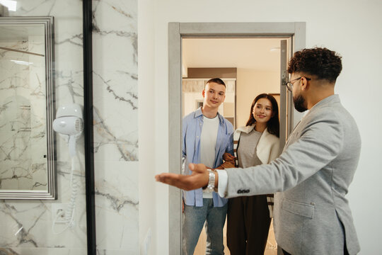 Real estate agent presenting property to young couple