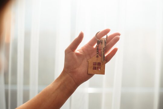 Hand holding house keys new home concept