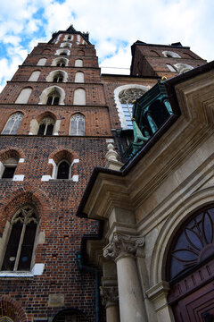 Gothic brick church tower viewed from below against a clear blue sky