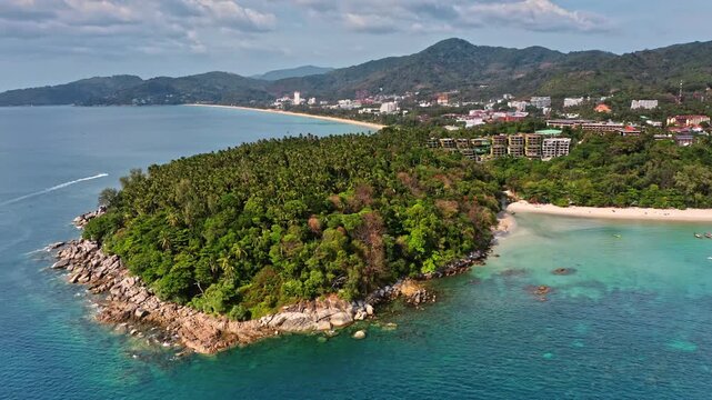 Phuket island offering a vibrant tropical vacation paradise with turquoise water, sandy beaches, lush green vegetation and bustling resorts along coastline. Travel Thailand. Aerial view drone panorama