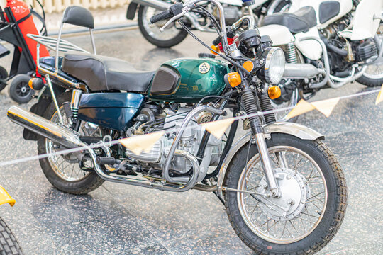 Antique KMZ Dnipro motorcycle in dimly lit room with concrete floor, parked and turned slightly to its right Prominent engine, exhaust system, large headlights, rou - Kyiv, Ukraine - October 25, 2025