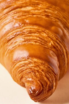 Crispy croissant close up with great texture. Front view