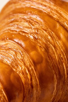 Flaky crispy croissant close up with great texture, full frame
