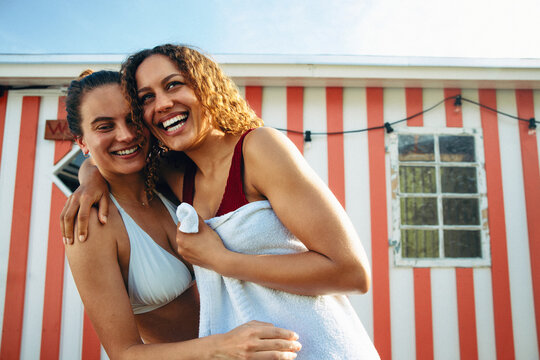 A swimwear moment highlights wellness and friends outside the sauna bathhouse