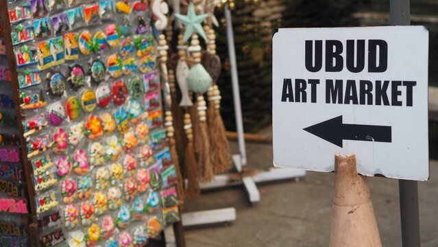Ubud Art Market sign with souvenir display in Bali, Indonesia travel destination.