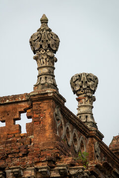 Ornate stone finials crowning the ruined facade of a zamindar mansion, Dhaka Division, Shivalaya, Bangladesh