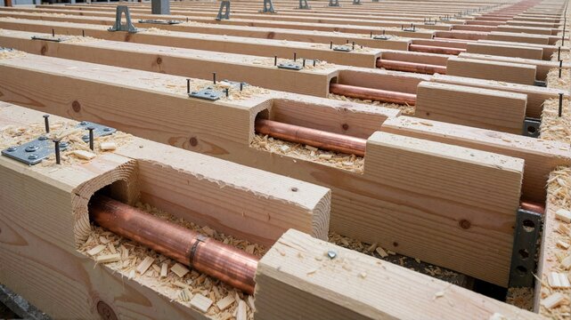 Construction site of a mass timber building with copper pipes