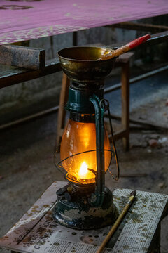 Oil lantern and paintbrush on a workbench in a textile workshop, Dhaka Division, Dhaka, Bangladesh