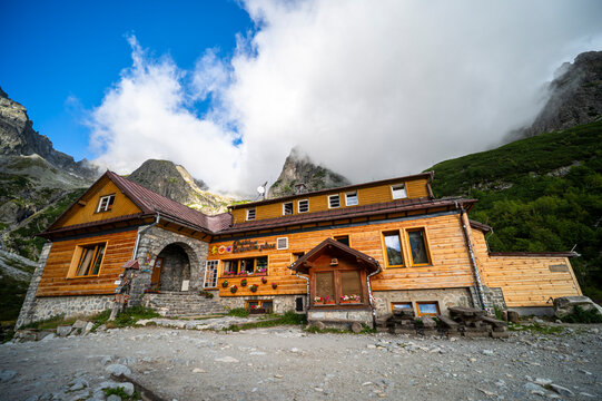 High Tatras, Slovakia - August 22, 2026: Wooden mountain hut Chata pri Zelenom plese surrounded by high Tatras peaks.