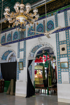 Golden ceremonial shrine draped with a red canopy inside the ornately tiled Hussaini Dalan sanctuary, Dhaka Division, Dhaka, Bangladesh