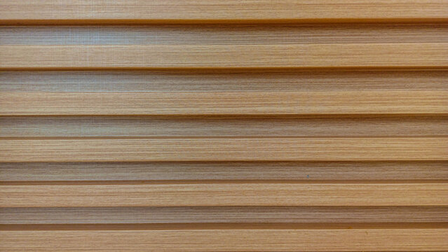 Light brown horizontal wooden slats wall paneling showing modern seamless linear pattern.