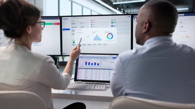 Human Resources Manager And Accountant Discuss Payroll