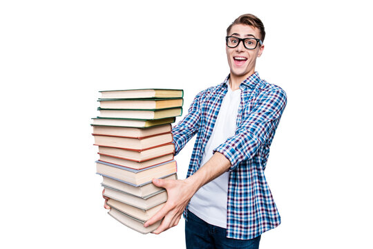 Portrait of good-looking, a-student, handsome reader high school teen in checkered shirt isolated on light gray background hold a lot of books in hands ans make big toothy smile