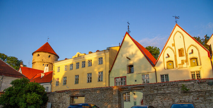 Beautiful morning view of historic medieval houses and Kiek in de Kok tower in Tallinn. Famous hanseatic architecture and ancient fortress wall in Estonia under a blue sky.