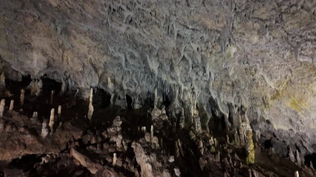 Rocky cave ceiling with small stalactites