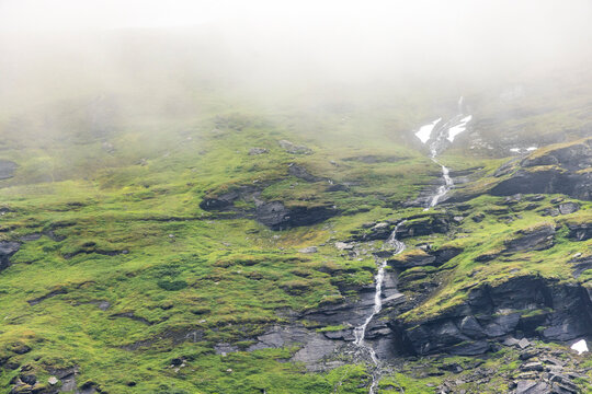 Fog Drifting Around Waterfalls and Snowy Mountain Slopes