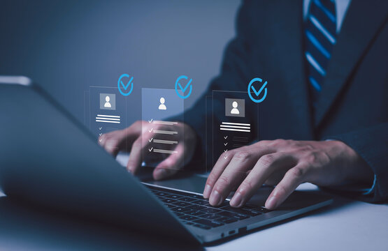 Businessman holding digital human resource icon with employee profiles, symbolizing recruitment, HR management, staff selection, corporate workforce strategy, and human capital development in modern.