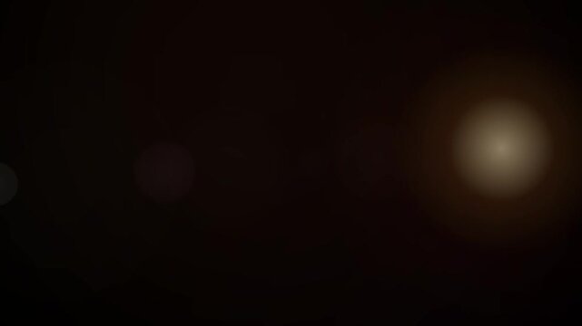 Dark background with soft glowing light orbs and subtle bokeh effect