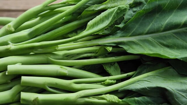 Fresh Chinese kale arranged in a natural wood plate