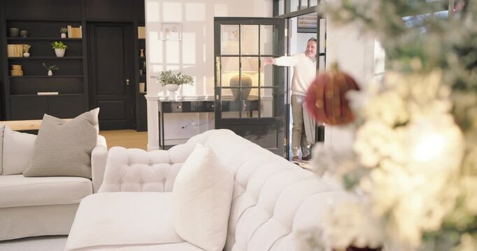 Diverse guests entering home after door opening, carrying suitcases and greeting dog near tree