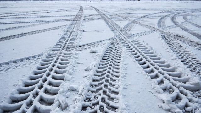 Intersecting Tire Tracks in Snow-Covered Ground